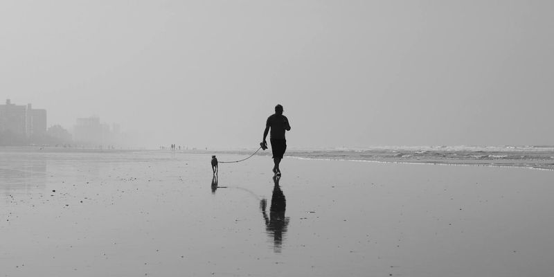 Wide shot of a person mid-exercise in a spacious loft.
